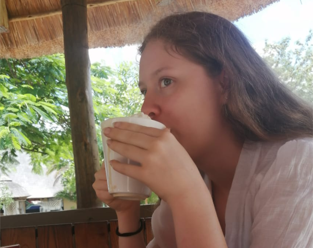 Candid photo of Janelle drinking coffee at a café